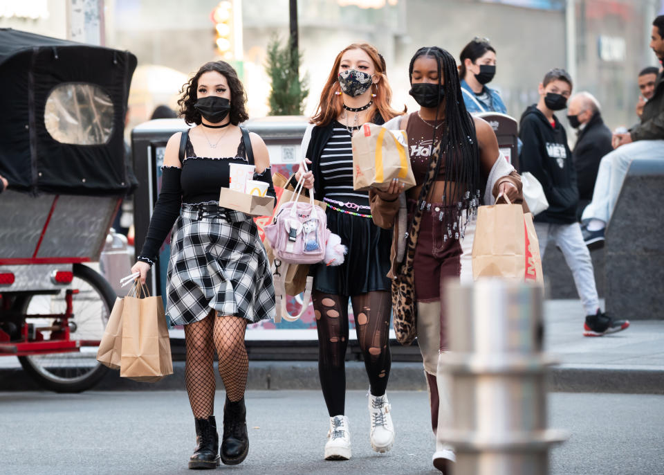 NEW YORK, NEW YORK - MARCH 30: People carry McDonald's take-out bags in Times Square amid the coronavirus pandemic on March 30, 2021 in New York City. After undergoing various shutdown orders for the past 12 months the city is currently in phase 4 of its reopening plan, allowing for the reopening of low-risk outdoor activities, movie and television productions, indoor dining as well as the opening of movie theaters, all with capacity restrictions. (Photo by Noam Galai/Getty Images)