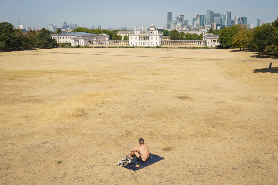 A man sunbathes in a nearly empty Greenwich Park, London, as a drought has been declared for parts of England following the driest summer for 50 years. Picture date: Sunday August 14, 2022.