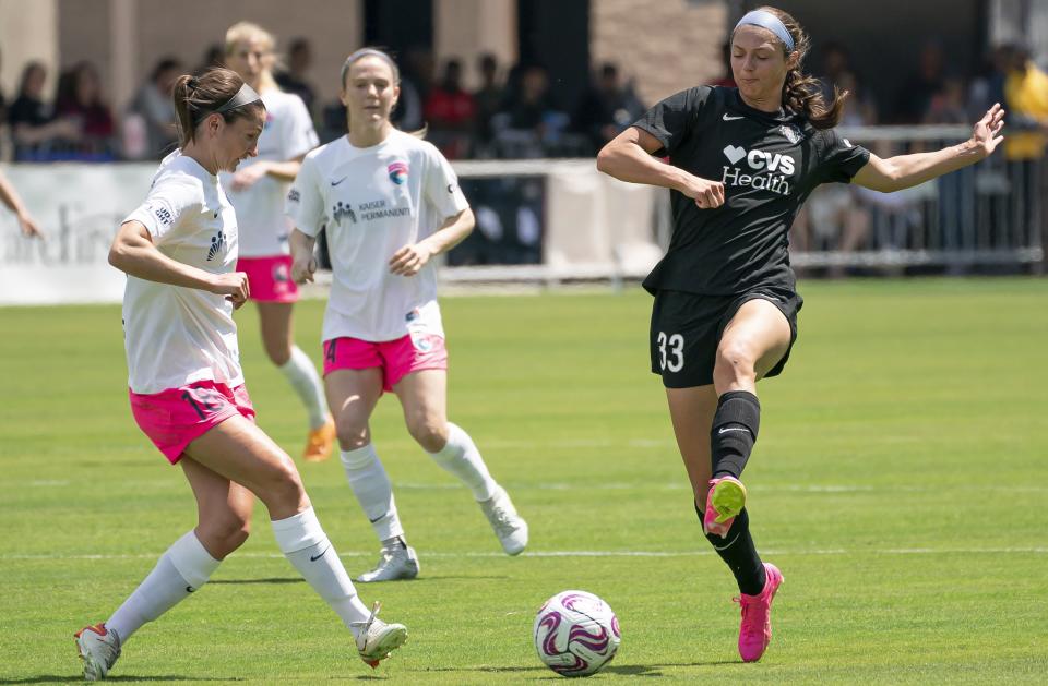 San Diego Wave defender Kaleigh Riehl, left, competes with Washington Spirit forward Ashley Hatch, right, during an NWSL soccer match on Saturday, May 6, 2023, in Washington. | Nathan Howard, Associated Press