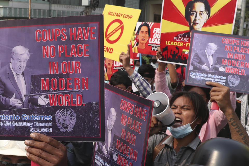 Anti-coup protesters hold up signs that read "Coups have no place in our modern world" as they march in Mandalay, Myanmar Sunday, March 14, 2021. The civilian leader of Myanmar's government in hiding vowed to continue supporting a "revolution" to oust the military that seized power in last month's coup, as security forces again met protesters with lethal forces. (AP Photos)