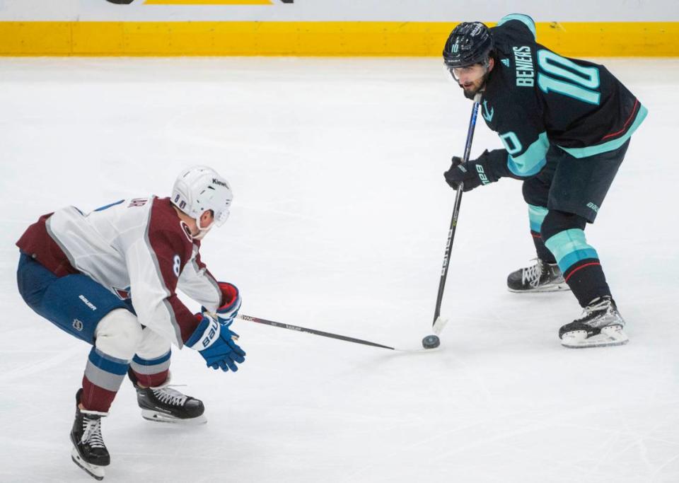 Seattle Kraken center Matty Beniers (10) moves the puck down the ice as Colorado Avalanche defenseman Cale Makar (8) tries to steal the puck during the second period of a first round 2023 Stanley Cup Playoffs game against the Colorado Avalanches at Climate Pledge Arena in Seattle on Monday, April 24, 2023.