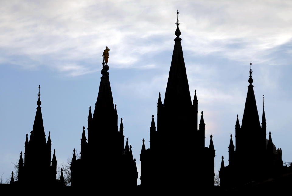 FILE- In this Jan. 3, 2018, file photo, the angel Moroni statue, silhouetted against the sky, sits atop the Salt Lake Temple at Temple Square in Salt Lake City. The Mormon church won't stand in the way of a proposal to ban gay conversion therapy for minors in its home base of Utah, a position that advocates heralded as a milestone in the conservative state. (AP Photo/Rick Bowmer, File)