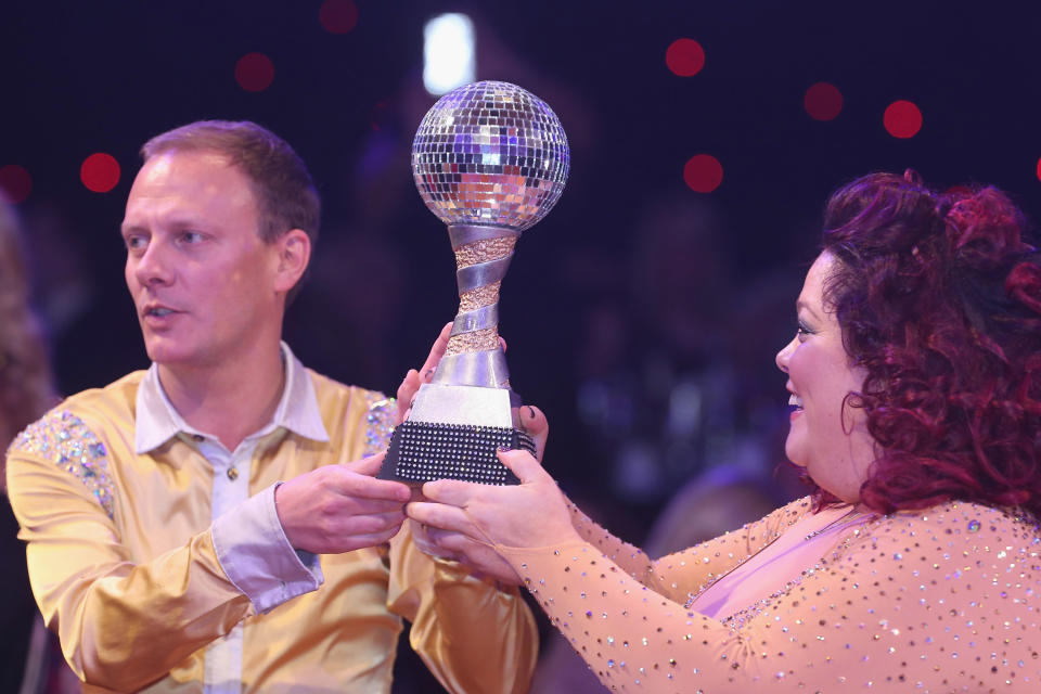 MANCHESTER, ENGLAND - MARCH 07:  (EXCLUSIVE COVERAGE) Antony Cotton and Lisa Riley pose with the winners' trophy as part of Dancing with United, in aid of the Manchester United Foundation, at Old Trafford on March 7, 2013 in Manchester, England.  (Photo by John Peters/Manchester United via Getty Images)