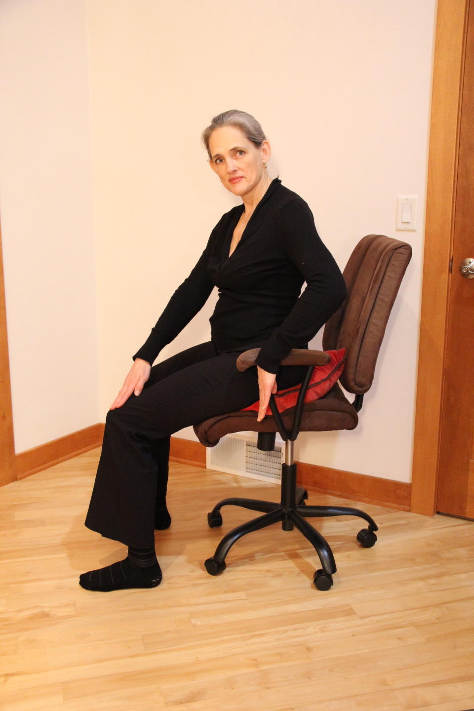 Sitting forward with a pillow on the diagonal can give sit bones support while allowing the thigh bones to slope down, Bryan advised. (Photo: The Body at Work Ergonomics/Sara Kraft)