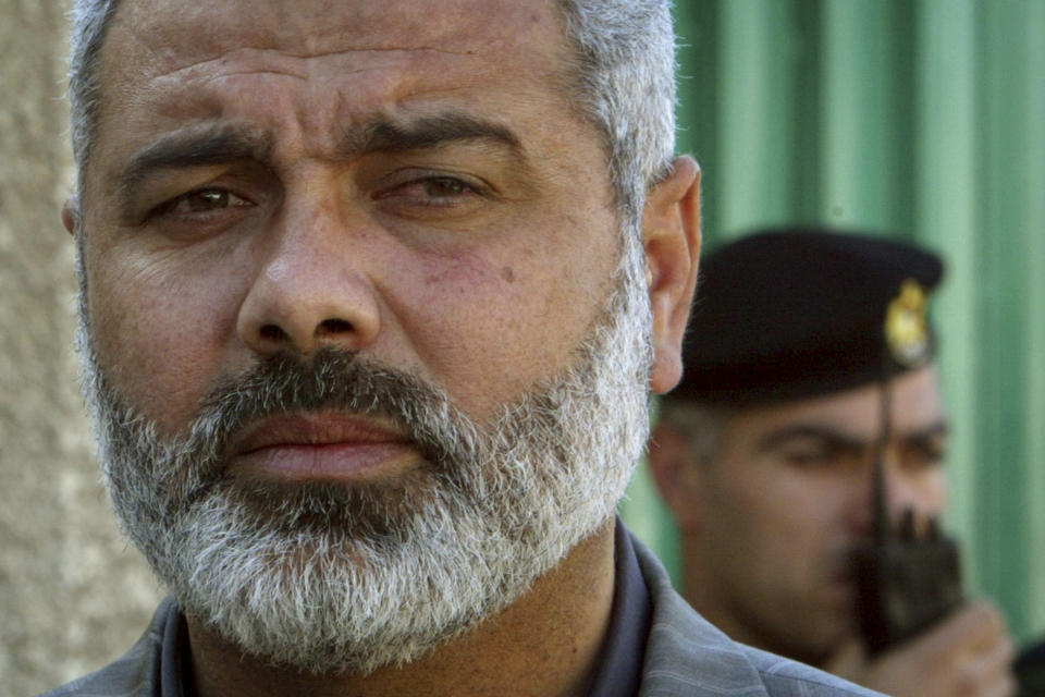 FILE - Palestinian Hamas leader Ismail Haniyeh speaks to the media after his meeting with Egyptian officials at the Egyptian diplomatic mission in Gaza City, Feb. 10, 2006. Hamas has refused to release more hostages until Israel ends its offensive and withdraws from Gaza. It wants a broader agreement that would include a long-term truce and reconstruction. The group's top political leader said Tuesday, Jan. 30, 2024, its priority is the "full withdrawal" of Israeli forces from Gaza. (AP Photo/Adel Hana, File)