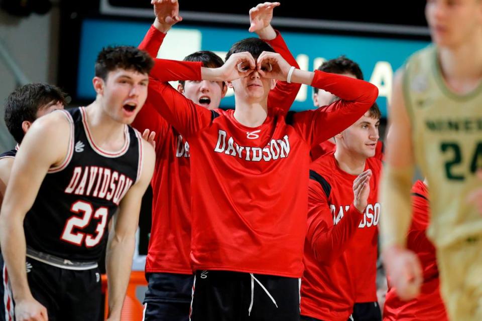The Davidson Wildcats celebrate from the bench during a game against the Charlotte 49ers at Belk Arena in Davidson, N.C., Tuesday, Nov. 29, 2022.