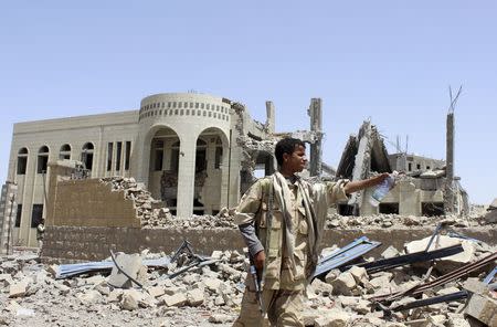 A Houthi militant stands in front of a court building, which was damaged in a Saudi-led air strike in Saada May 31, 2015. REUTERS/Stringer