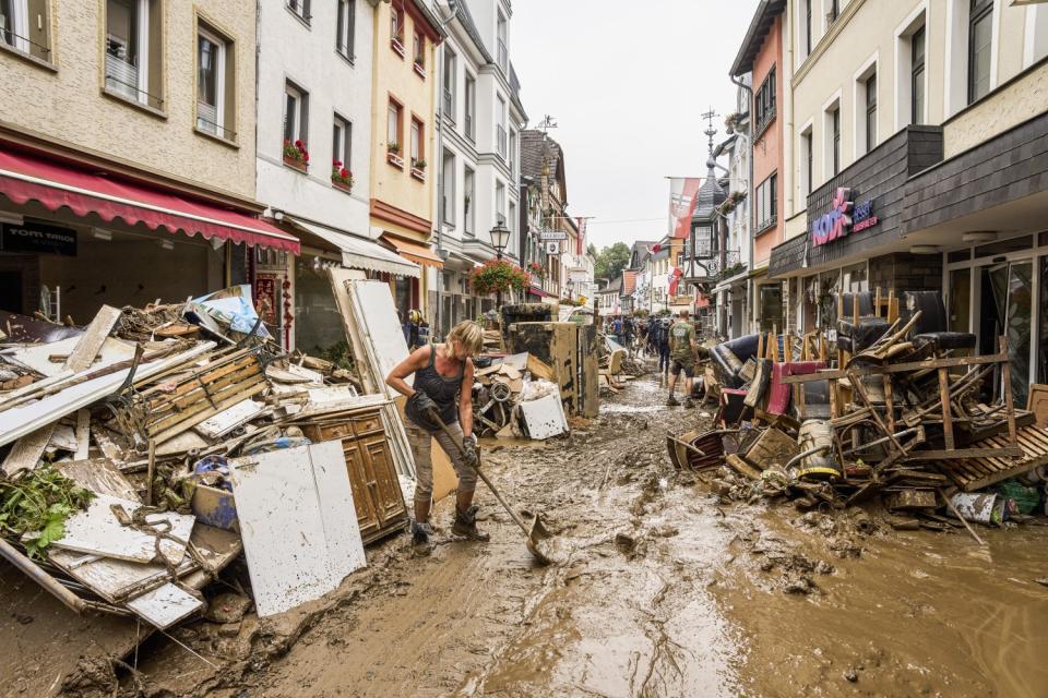 Residents and shopkeepers trying to clear mud