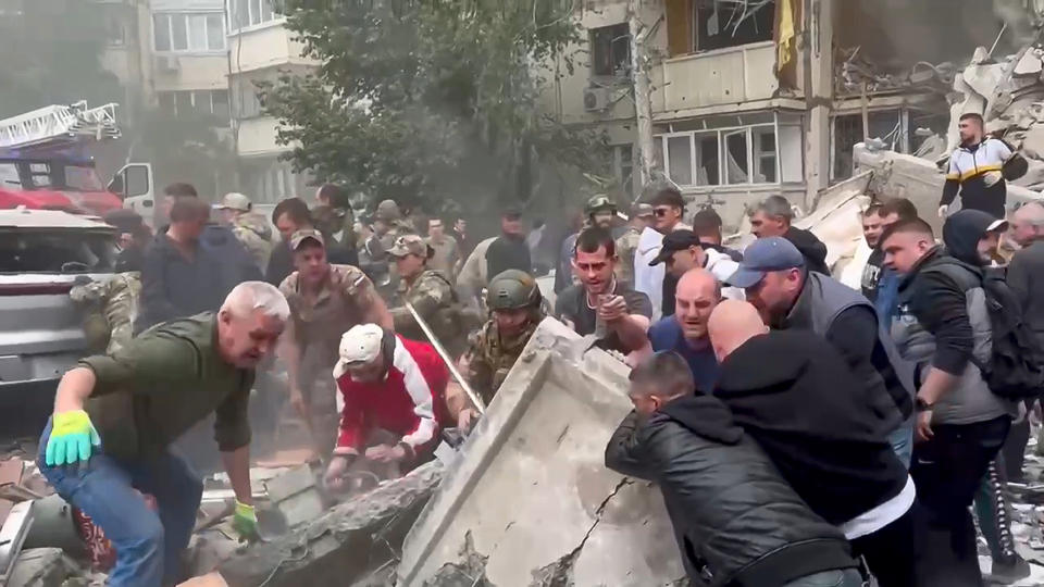This photo taken from video released by Belgorod regional governor Vyacheslav Gladkov's Telegram channel on Sunday, May 12, 2024, volunteers work at the scene of a partially collapsed block of flats after a missile attack by the Ukrainian Armed Forces in the Russian city of Belgorod, Russia. In a statement, Russia's Investigative Committee, the country's top law enforcement agency, said that the 10-story block had been hit by Ukrainian shelling. (Belgorod Region Governor Vyacheslav Gladkov Telegram channel via AP)