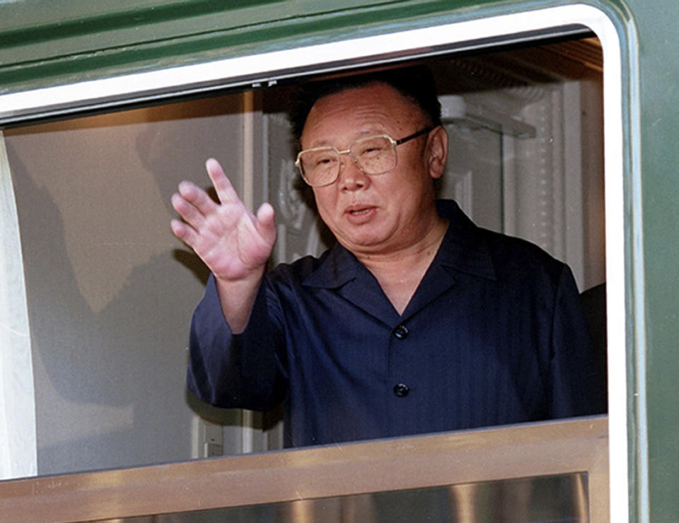 FILE - Then North Korean leader Kim Jong Il waves out of a window of his armored train at the Russian border railway station of Khasan, Russia, on Aug. 20, 2002. North Korea’s Kim Jong Un's train journey to Russia has a storified history. The tradition of train travel extends across the generations. That’s in evidence at the massive Kumsusan Palace of the Sun, where reconstructions of Kim Jong Un’s father’s and grandfather’s train cars, and the leaders’ preserved and displayed remains, are enshrined. (AP Photo/Igor Kochetkov, File)