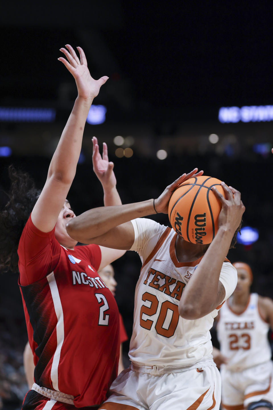 Texas forward Khadija Faye (20) looks to shoot as North Carolina State forward Mimi Collins (2) defends during the first half of an Elite Eight college basketball game in the women's NCAA Tournament, Sunday, March 31, 2024, in Portland, Ore. (AP Photo/Howard Lao)