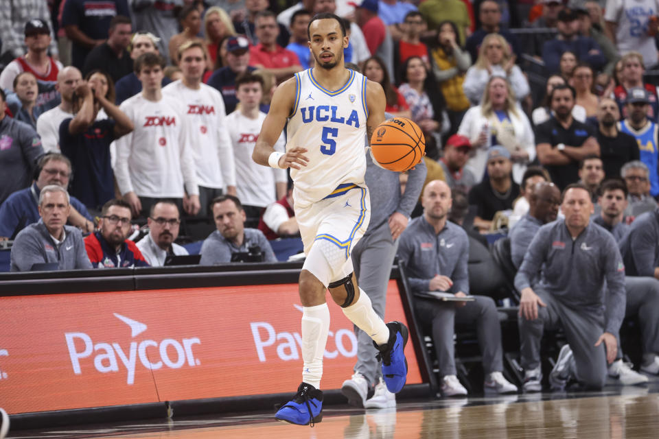 UCLA guard Amari Bailey (5) brings the ball up against Arizona during the second half of an NCAA college basketball game for the championship of the men's Pac-12 Tournament, Saturday, March 11, 2023, in Las Vegas. (AP Photo/Chase Stevens)