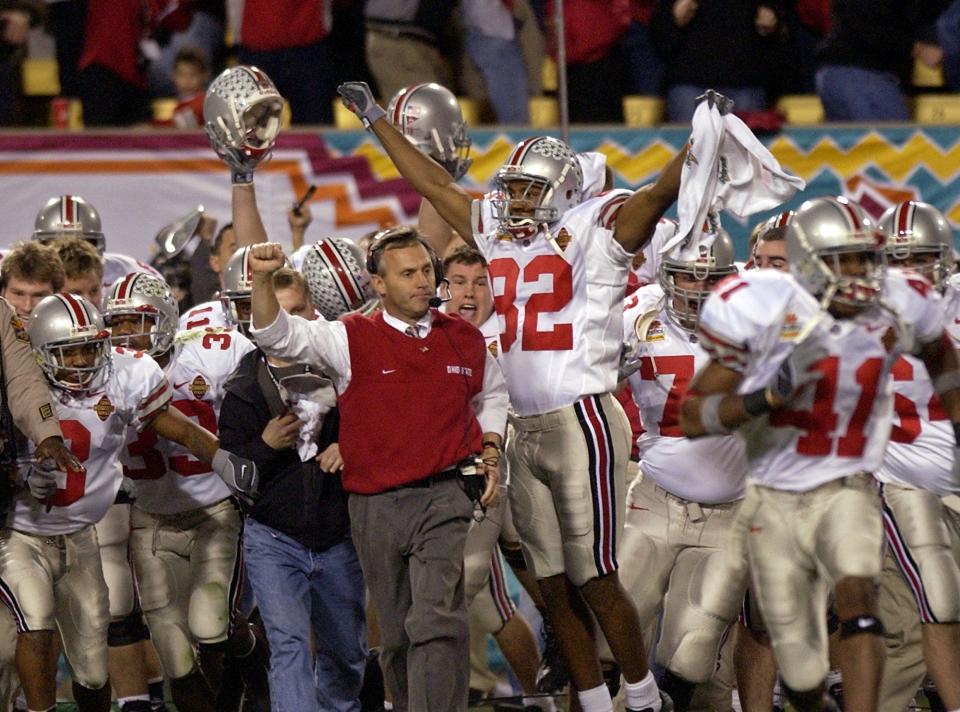 Jim Tressel and the Ohio State football team celebrate a national championship as time runs out in the second overtime of the 2003 Fiesta Bowl in Tempe, Ariz., on Jan. 3, 2003.