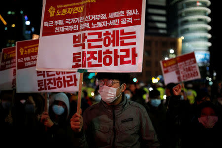 Protesters take part in a protest denouncing South Korean President Park Geun-hye over a recent influence-peddling scandal in central Seoul, South Korea, October 29, 2016. The banner reads, "Call for Park Geun-hye to step down". REUTERS/Kim Hong-Ji