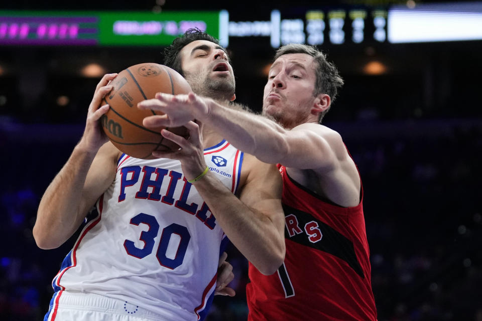 Philadelphia 76ers' Furkan Korkmaz, left, tries to go up for a shot against Toronto Raptors' Goran Dragic during the second half of a preseason NBA basketball game, Thursday, Oct. 7, 2021, in Philadelphia. (AP Photo/Matt Slocum)