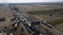 Trucks sit idle on the Pan-American South Highway during a blockade set up by farmworkers, on the fourth day of protests against the Agricultural Promotion Law, in Villacuri, Ica province, Peru, Thursday, Dec. 3, 2020. The farmworkers are asking for the elimination of the law, demanding better wages and health benefits. (AP Photo/Rodrigo Abd)