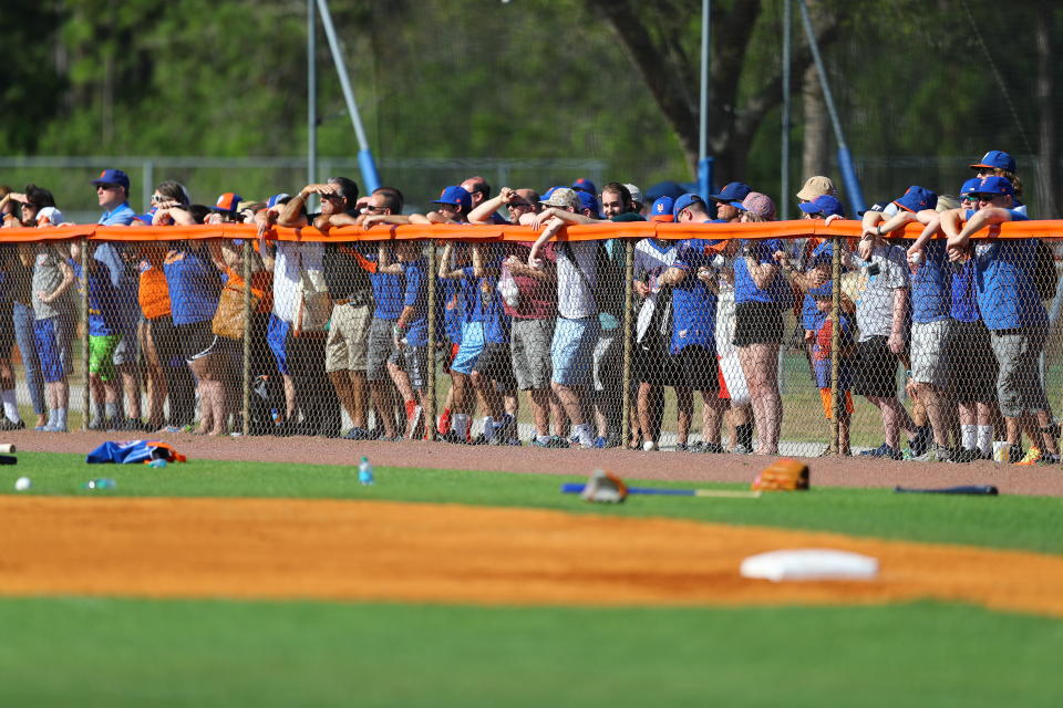 <p>New York Mets fans line up along the fences to watch players during spring training workouts at the Mets Minor League Complex in Port St. Lucie, Fla., Feb. 25, 2018. (Photo: Gordon Donovan/Yahoo News) </p>