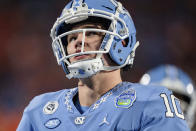 North Carolina quarterback Drake Maye warms up before the Atlantic Coast Conference championship NCAA college football game against Clemson on Saturday, Dec. 3, 2022, in Charlotte, N.C. (AP Photo/Jacob Kupferman)