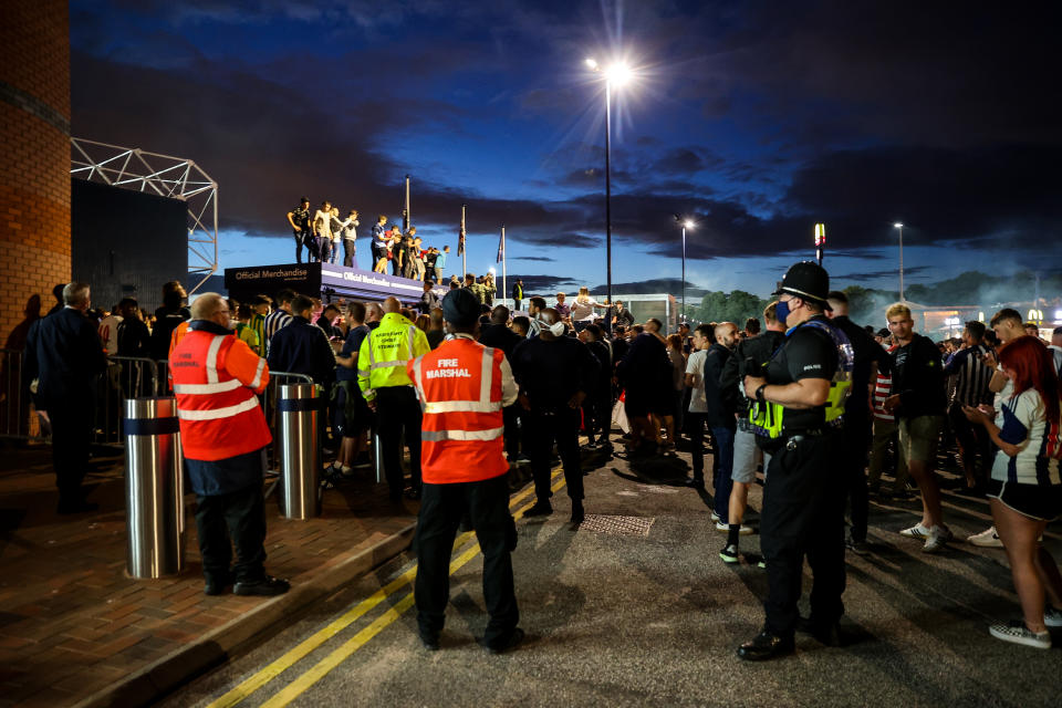 Fans of West Bromwich Albion celebrate outside the stadium as promotion to the Premier League is confirmed.