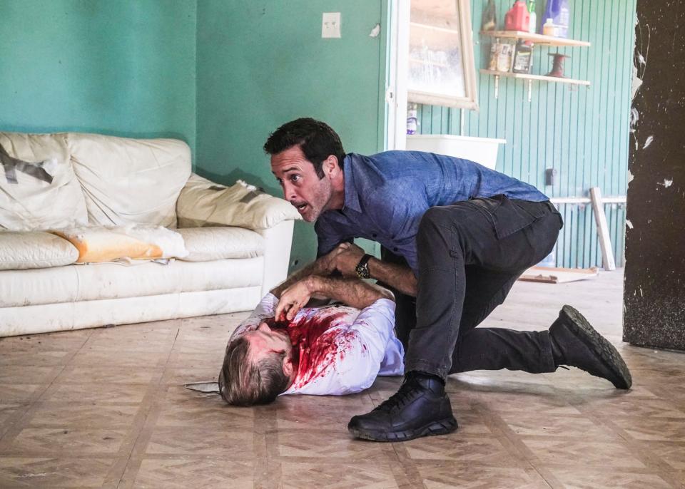 Steve McGarrett (Alex O'Loughlin), top, helps his critically injured friend and colleague Danny Williams (Scott Caan) in the series finale of CBS' 'Hawaii Five-0.'