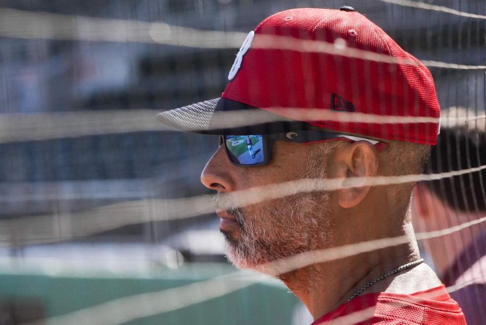 Red Sox manager Alex Cora watches workouts of starting pitchers during spring training in Fort Myers, Fla., Thursday, Feb. 15, 2024. (AP Photo/Gerald Herbert)