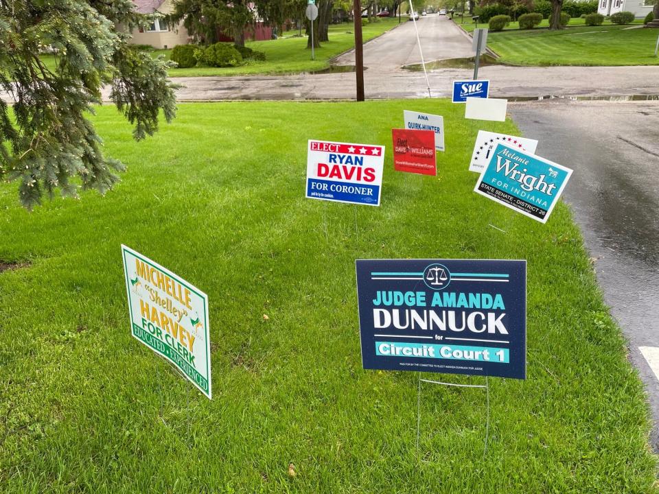 Signs are displayed along the parking lot of a polling site on Primary Election Day, Tuesday, May 3, 2022, in Muncie.