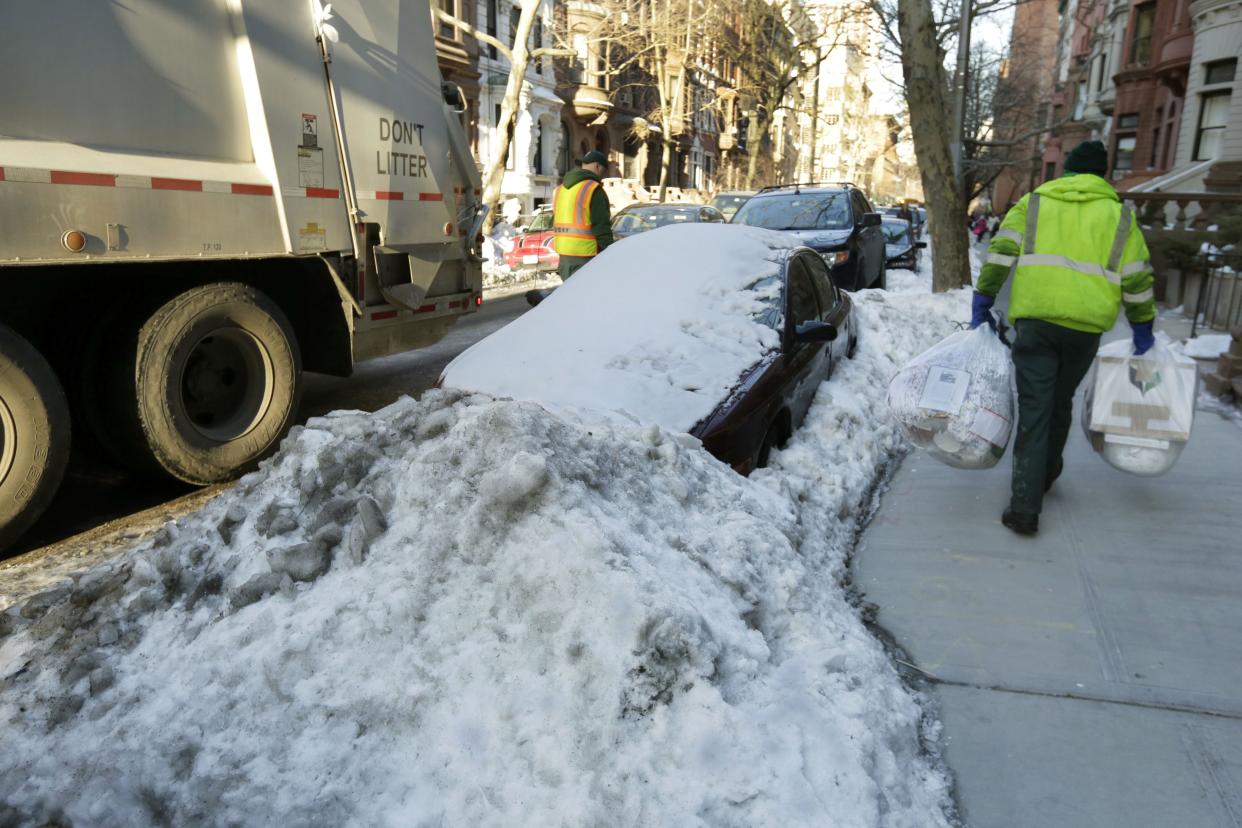 New York City Department of Sanitation workers collect recycling.