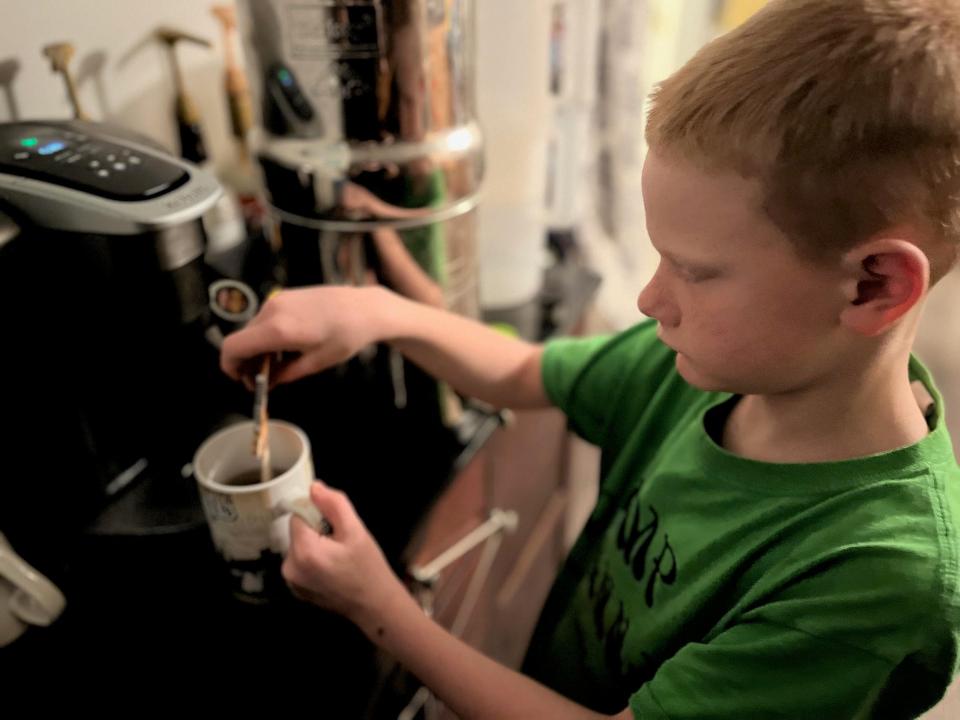 lisa's son making himself a hot drink in the morning