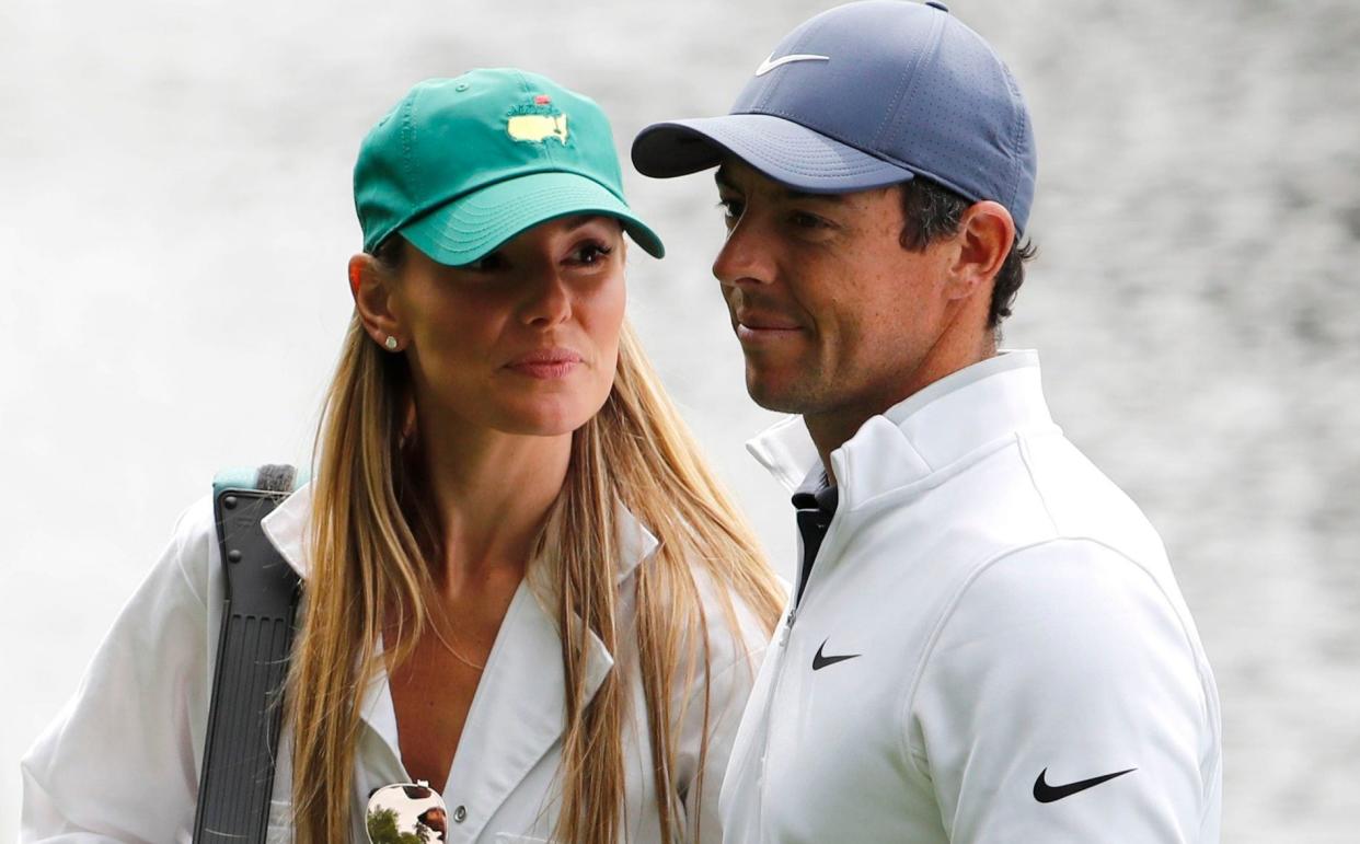 Rory McIlroy of Northern Ireland walks with his wife Erica Stoll during the par 3 contest held on the final day of practice for the 2018 Masters golf tournament