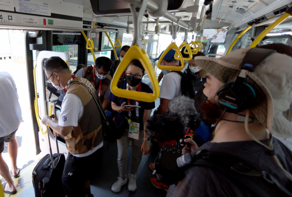 Media members ride the bus from the Main Press Center at Tokyo Big Sight to the transport hub ahead of the Tokyo 2020 Olympic Games on July 22, 2021 in Tokyo, Japan.<span class="copyright">Elsa—Getty Images</span>