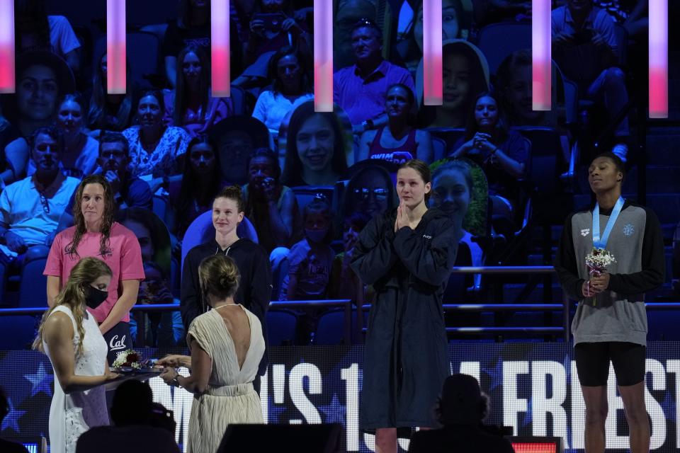 Right to left on the medal stand for the women's 100 freestyle are Natalie Hinds, Olivia Smoliga, Erika Brown and Abbey Weitzeil during wave 2 of the U.S. Olympic Swim Trials on Friday, June 18, 2021, in Omaha, Neb. (AP Photo/Jeff Roberson)