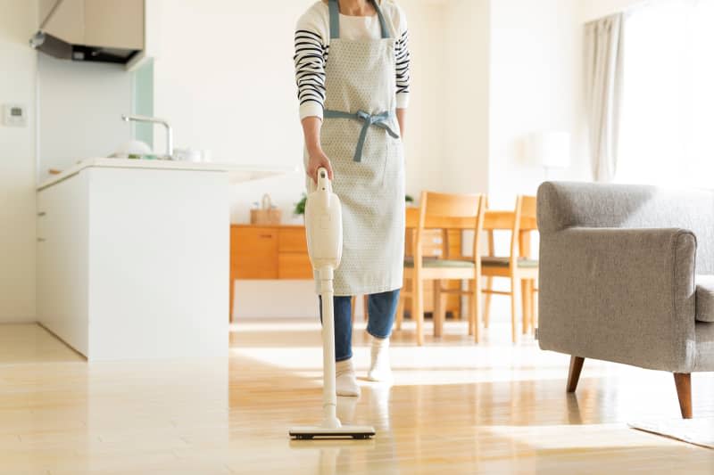 Woman vacuuming kitchen