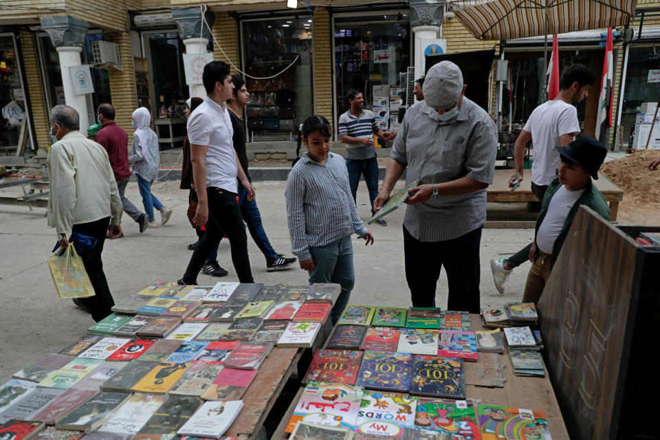 People shop for supplies in preparation for the new school year in Baghdad, Iraq, Sunday, Oct. 31, 2021. Across Iraq, students returned to classrooms Monday for the first time in a year and a half – a stoppage caused by the coronavirus pandemic - amid overcrowding and confusion about COVID-19 safety measures. (AP Photo/Khalid Mohammed)