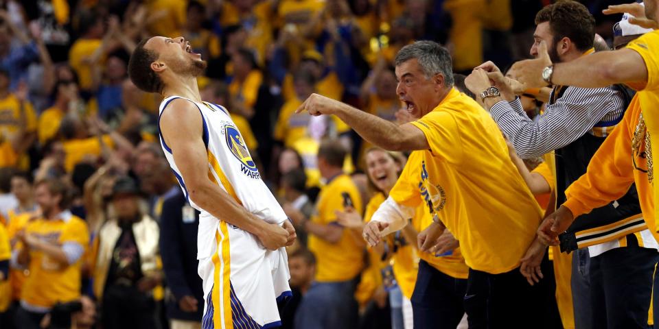 Apple exec Eddy Cue celebrating at a Golden State Warriors basketball game.