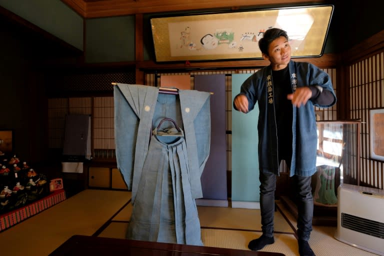 Craftsman Yuichi Hirose shows off an old kimono made for a samurai during the Edo period (between 1603-1868)