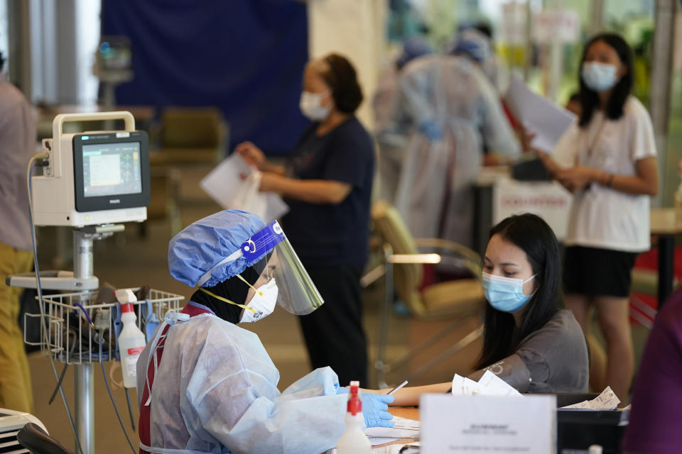 Residents register for coronavirus testing at a private hospital in Sunway, on the outskirt of Kuala Lumpur, Malaysia, Wednesday, Oct. 7, 2020. (AP Photo/Vincent Thian)