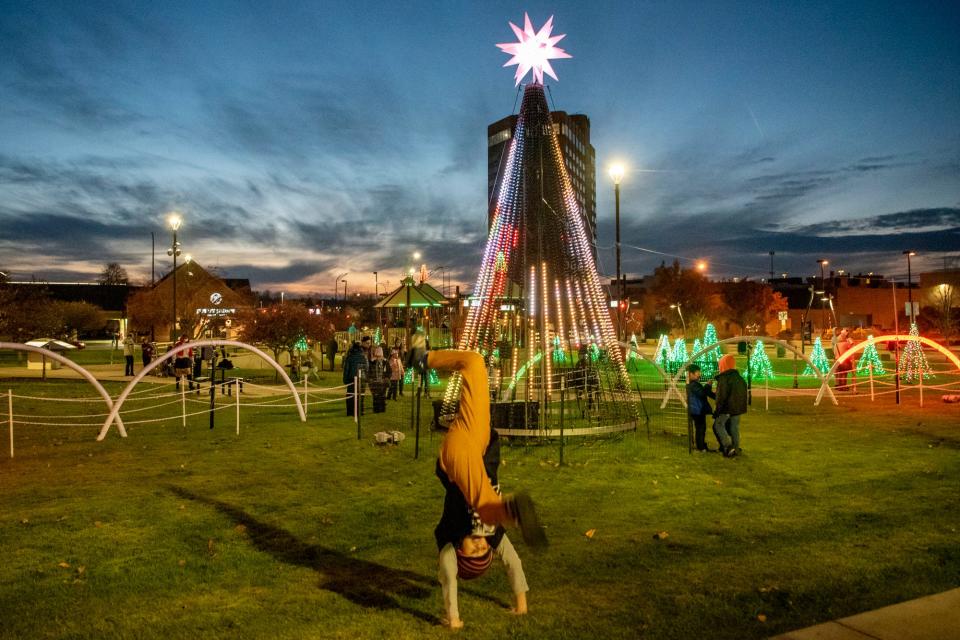 Kasen Powell, 11, performs handsprings before the Battle Creek Christmas Parade on Saturday, Nov. 20, 2021.