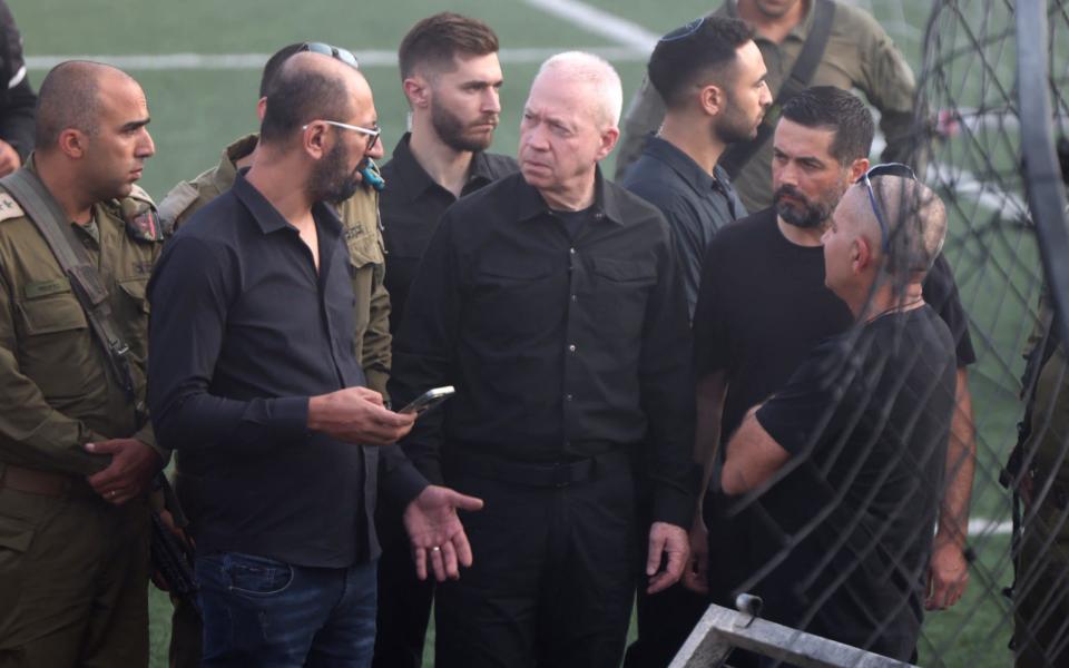 Yoav Gallant, centre, the Israeli minister of defence visited the site of the strike