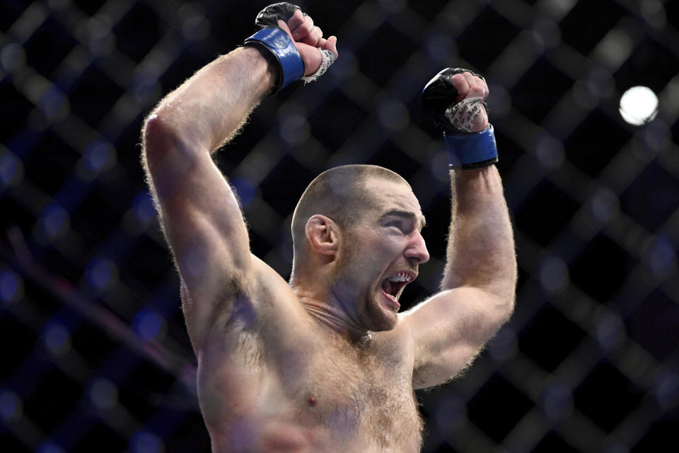 American Sean Strickland celebrates defeating Nigerian-born New Zealander Israel Adesanya to claim the middleweight title by unanimous decision in the main event of UFC 293 in Sydney, Sunday, Sept. 10, 2023. (Dan Himbrechts/AAP Image via AP)