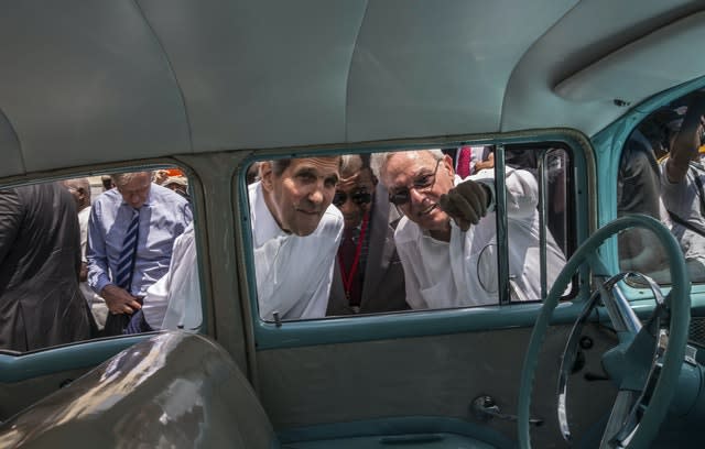 FILE – In this Aug. 14, 2015 file photo, Havana city historian Eusebio Leal Spengler, right, points out something to then US secretary of state John Kerry as they peer into the interior of a classic American car parked in Old Havana, Cuba (Ramon Espinosa/AP)