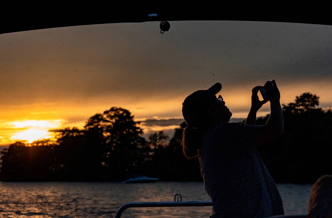 Karen Mott photographs Purple Martins at Bomb Island on Lake Murray. Wildlife specialist Zach Steinhauser takes visitors out on Lake Murray to see the Purple Martins flocking to Bomb Island.