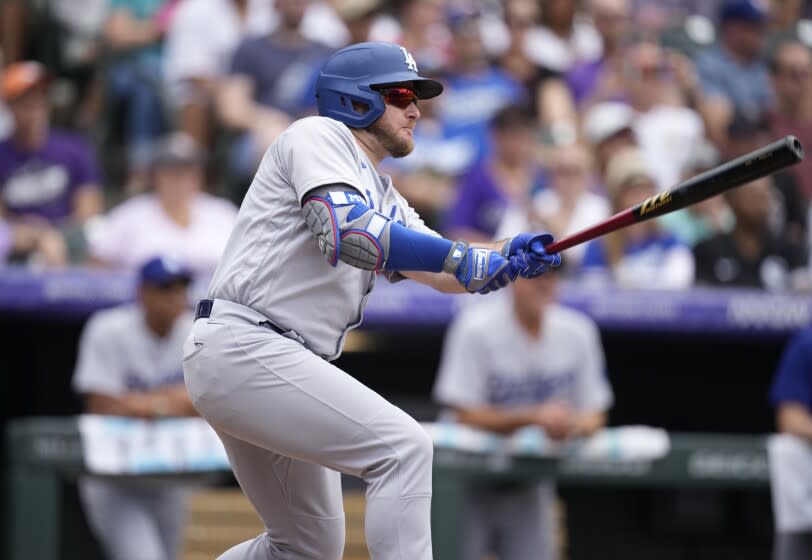 Los Angeles Dodgers' Max Muncy follows the flight of his sacrifice fly to drive in a run off Colorado Rockies.