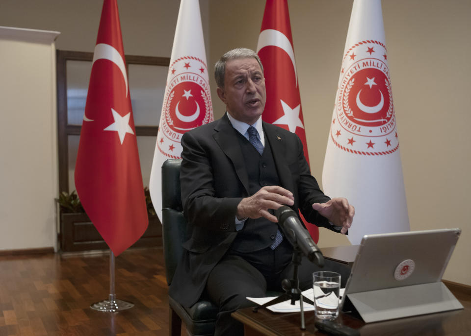 Turkey's Defense Minister Hulusi Akar speaks during an interview with the Associated Press, in Ankara, Turkey, Tuesday, Feb. 11, 2020. Akar said as many as four observation posts and two military positions are now in Syrian-controlled territory as the Syrian forces continued their advance into northwestern Idlib province, the last rebel stronghold and warned Turkish soldiers were under orders to retaliate forcefully to attacks on the military posts.(AP Photo/Burhan Ozbilici)