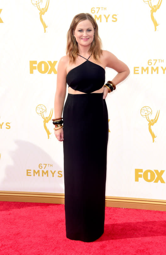 The top of Amy Poehler’s black halter dress connected to the skirt with just a little tip, which showed off the sides of her torso. 