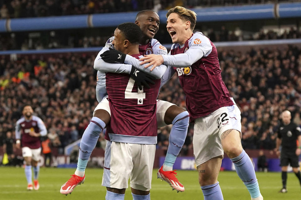 Aston Villa's scorer Ezri Konsa, front, and his teammates celebrate their side's second goal during the English Premier League soccer match between Aston Villa and Wolverhampton Wanderers in Birmingham, England, Saturday, March 30, 2024. (Bradley Collyer/PA via AP)