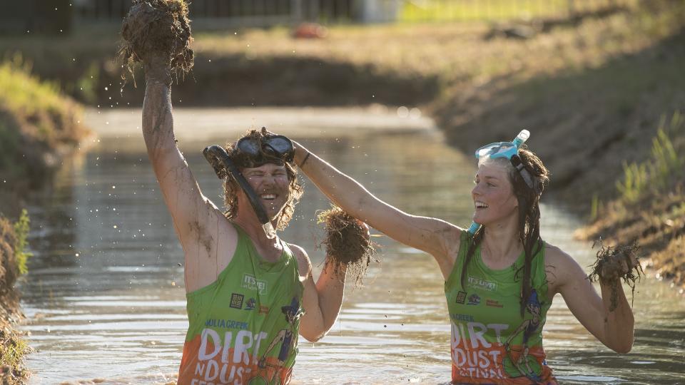 Neil Batt and Aimie Athorn cover each other in mud during a media opportunity at the bog snorkelling pit at the Dirt 'n' Dust Festival 2017