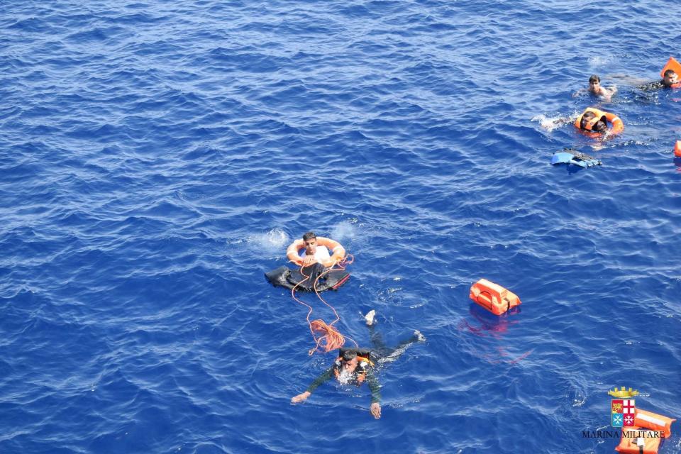 SICILIAN STRAIT, MEDITERRANEAN SEA - MAY 25: Italian marines rescue migrants from a capsized boat at Sicilian Strait, between Libya and Italy, in Mediterranean sea on May 25, 2016. The Italian Navy saved around 500 migrants as they found dead bodies of seven migrants in the sea during the operations. (Photo by Italian Navy / Marina Militare/Anadolu Agency/Getty Images)