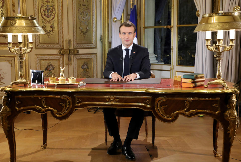 French President Emmanuel Macron poses before a special address to the nation, his first public comments after four weeks of nationwide 'yellow vest' protests, at the Elysee Palace, in Paris, Monday, Dec. 10, 2018. Facing exceptional protests, French President Emmanuel Macron is promising to speed up tax relief for struggling workers and to scrap a tax hike for retirees. (Ludovic Marin/Pool Photo via AP)