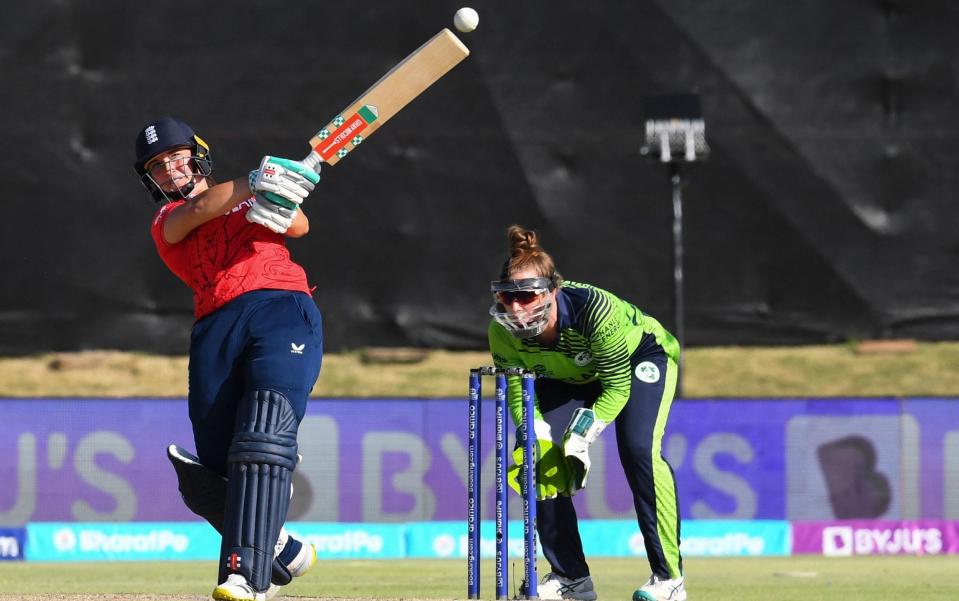 England's Alice Capsey (L) watches the ball after playing a shot as Ireland's wicketkeeper Mary Waldron (R) looks on during the Group B T20 women's World Cup cricket match between Ireland and England at Boland Park in Paarl on February 13, 2023 - RODGER BOSCH/AFP via Getty Image