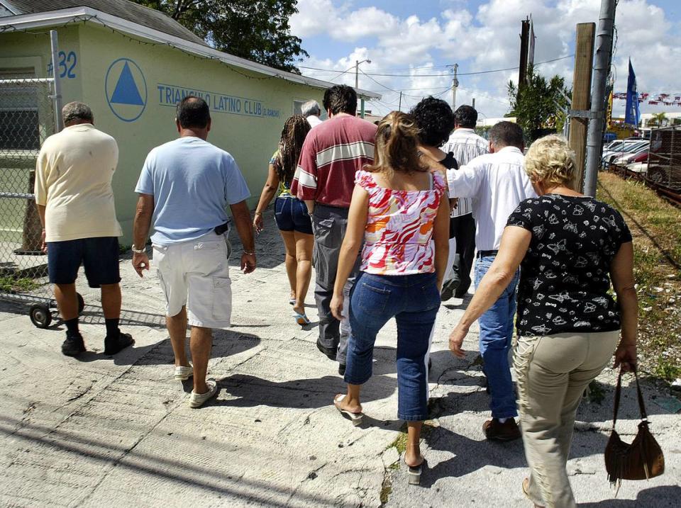 Members of Alcoholics Anonymous enter the gates as they attend a meeting in Little Havana. Since the coronavirus outbreak, many meetings have moved online.